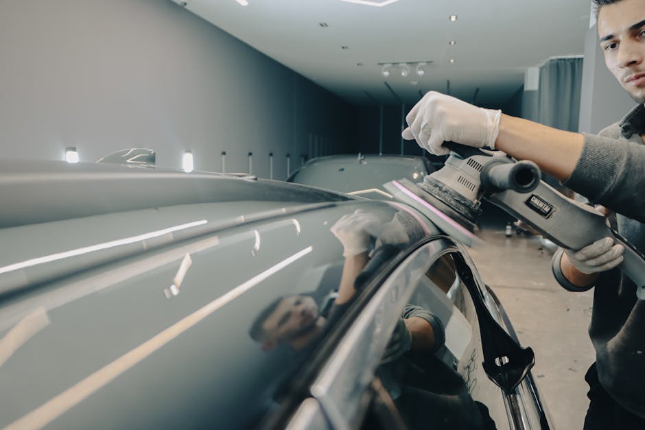 Auto detailer working on paint protection